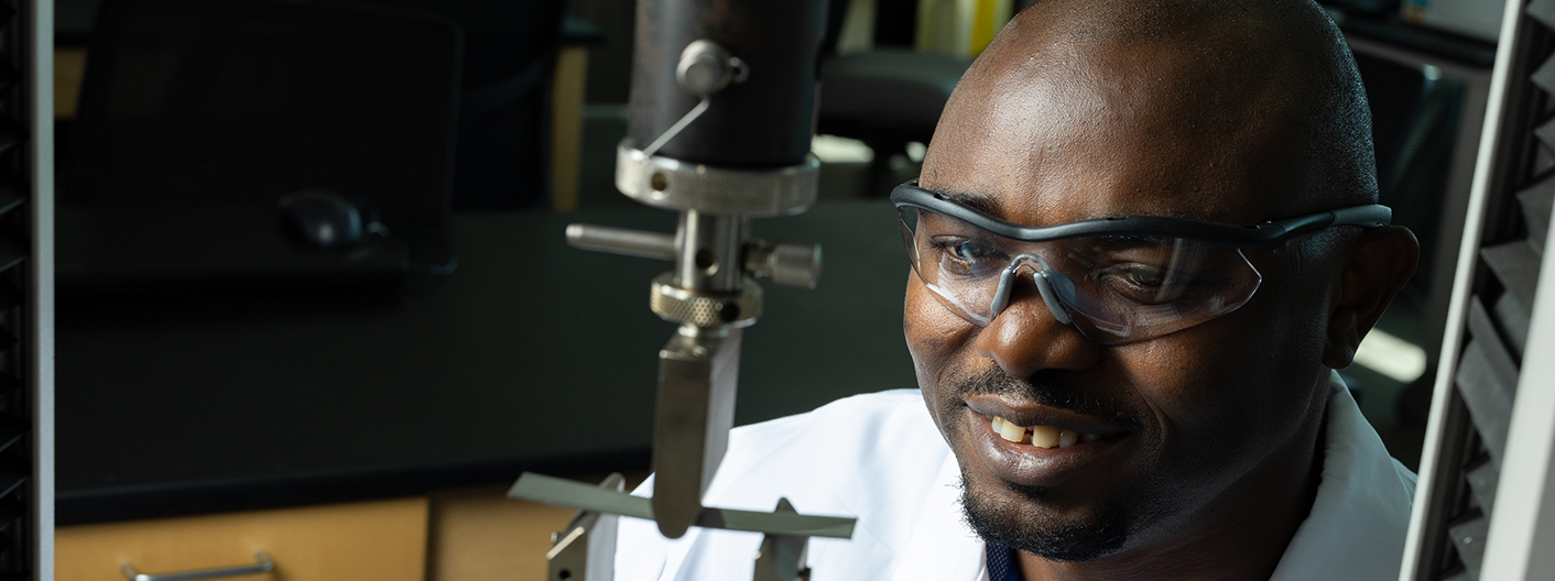 Student works with metals in a lab.